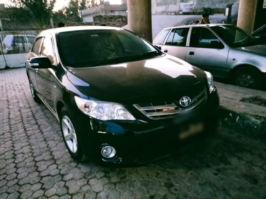 Black Toyota Corolla car parked on street.