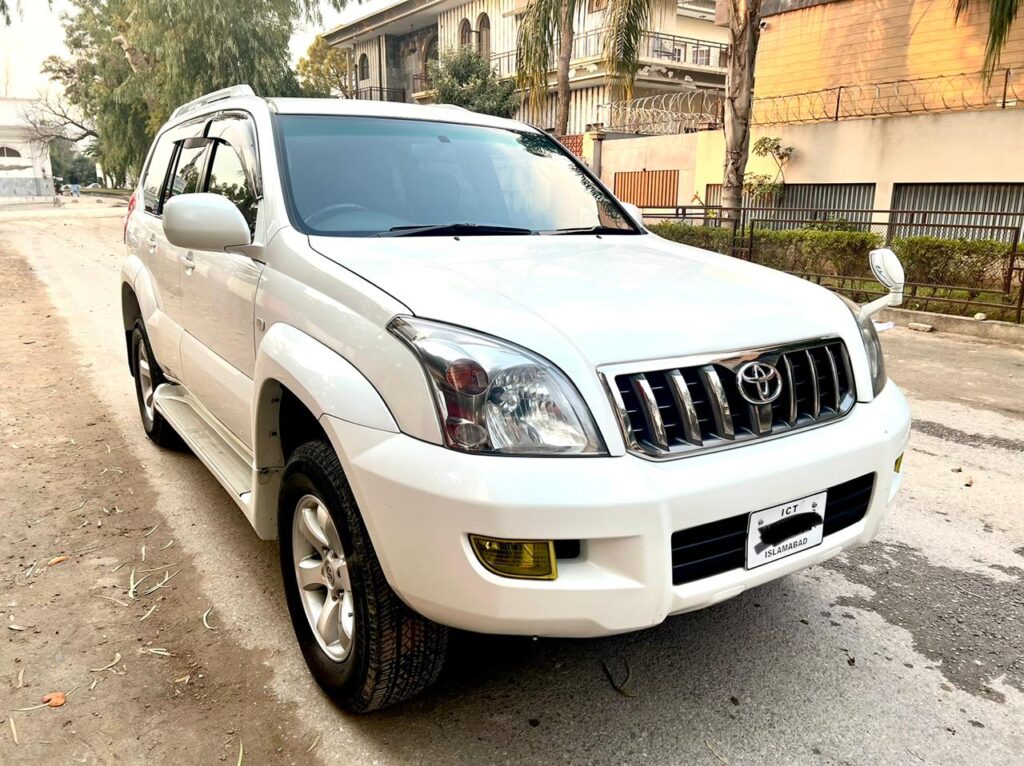 A white SUV is parked on a street.