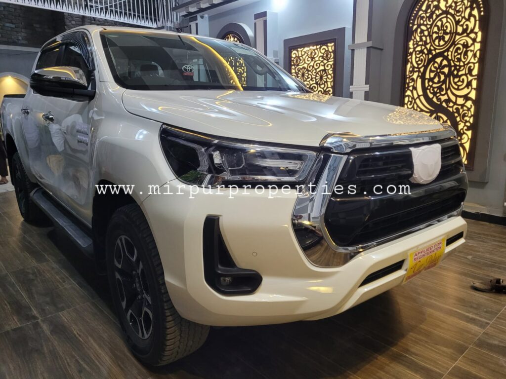 A white Toyota Hilux pickup truck.