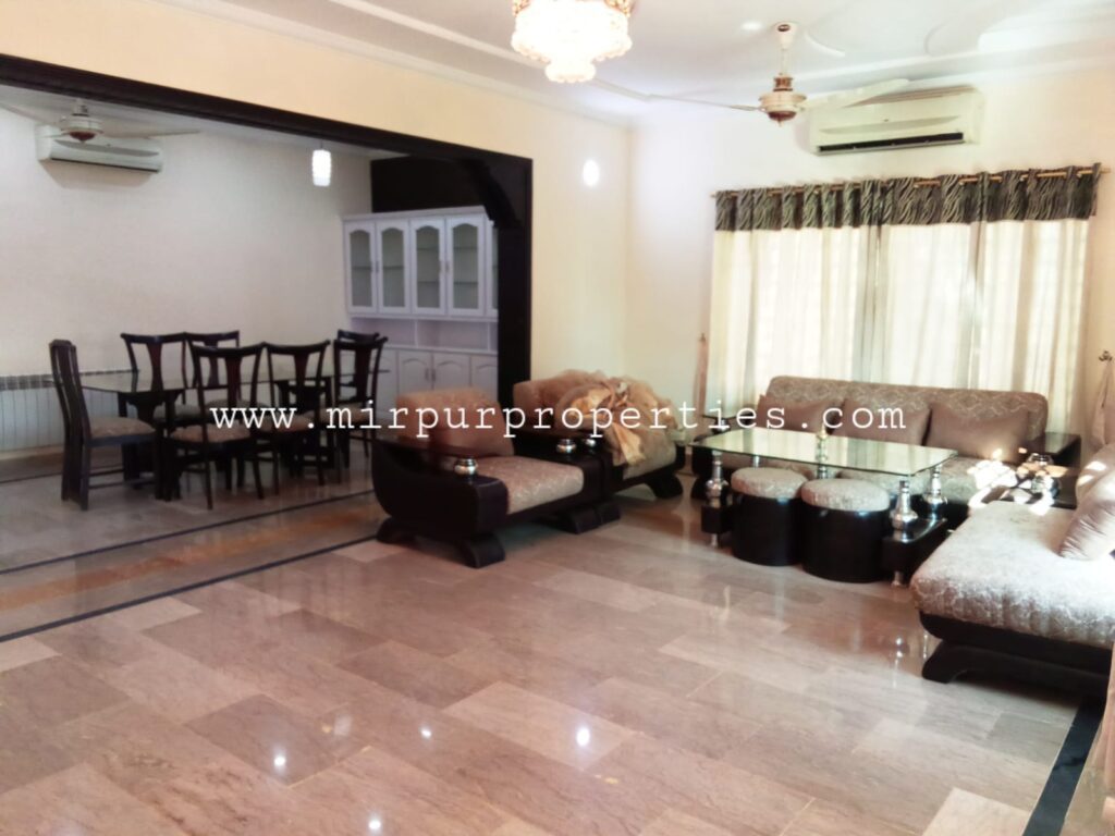 An apartment in Islamabad with a dining table and chairs in the living room.