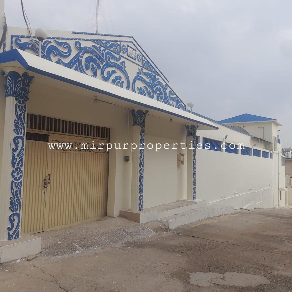 Located in Sector D-4 of Mirpur, Azad Kashmir, this building features a striking blue door.