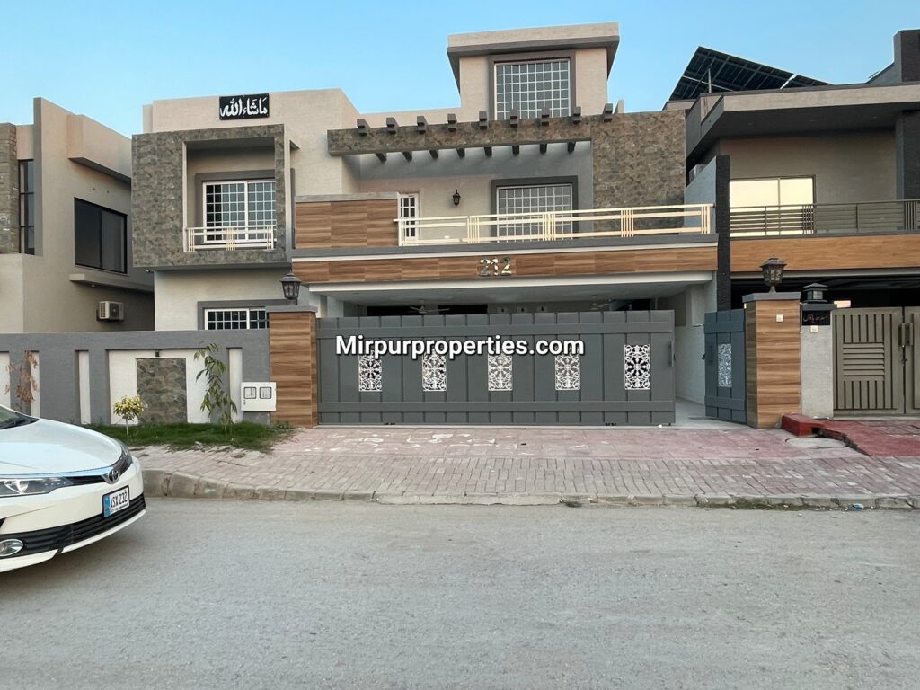 A white car is parked in front of House No 212 in Bahria Town, Phase 8, Rawalpindi.