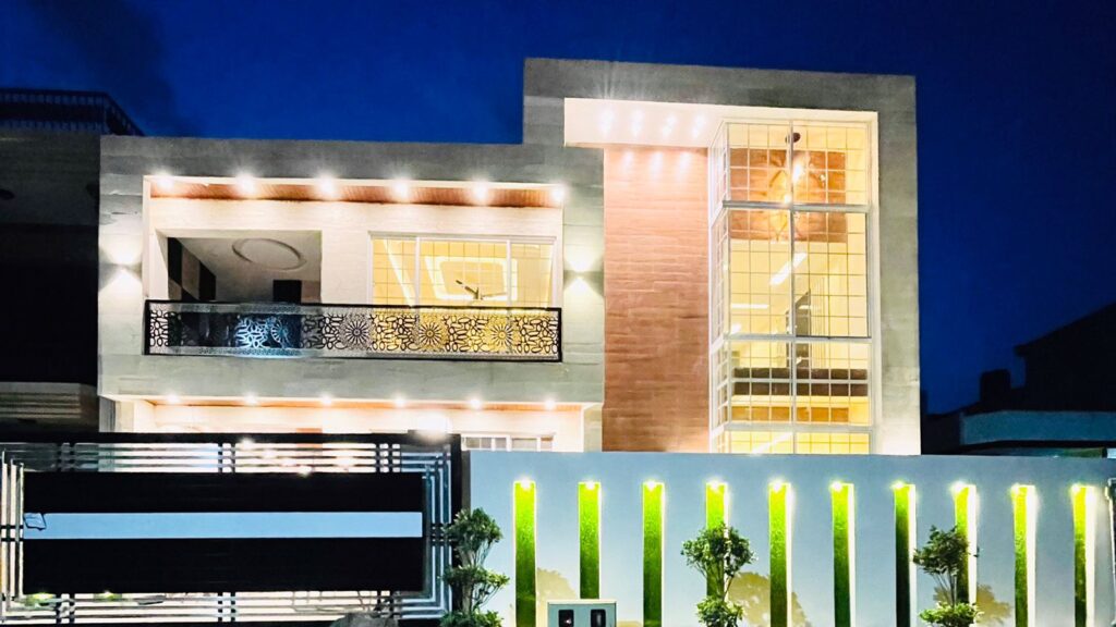 House for sale. A modern house is illuminated at night.