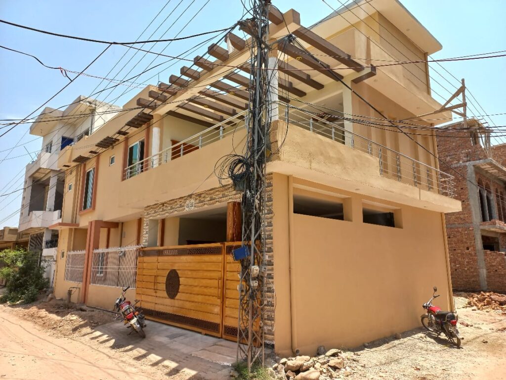 A house with a motorcycle parked in front of it in Islamabad.