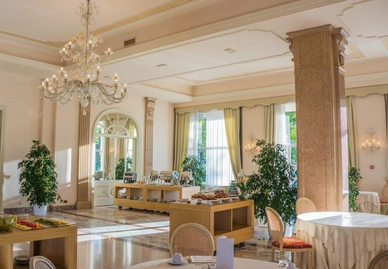 Elegant dining room with large chandelier.