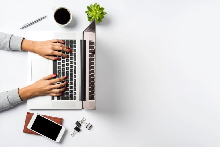 Person typing on a laptop computer.