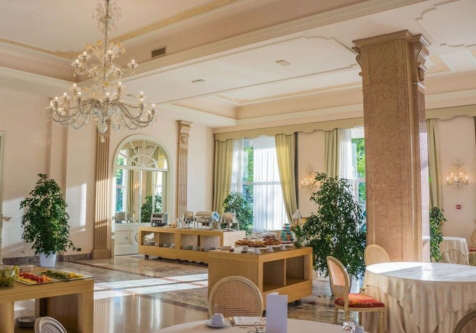 Elegant dining room with large chandelier.