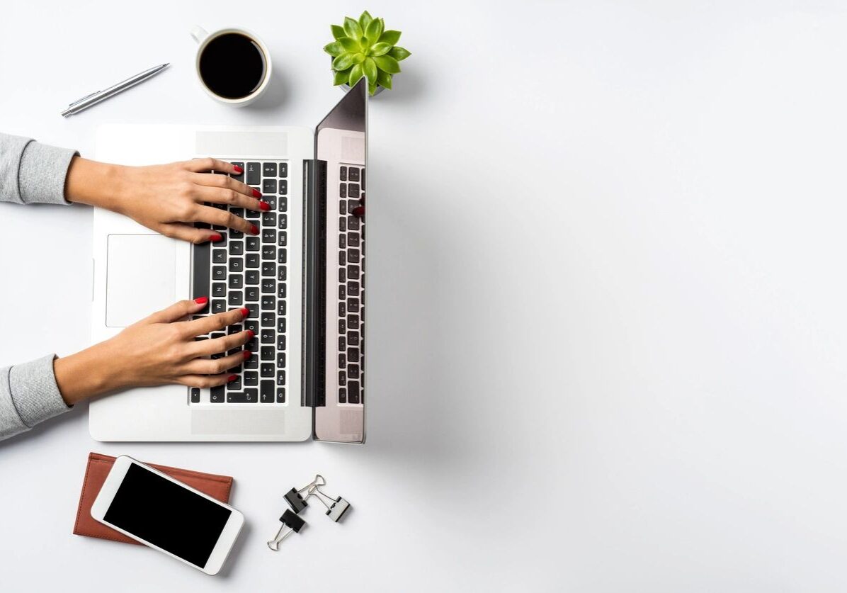 Person typing on a laptop computer.